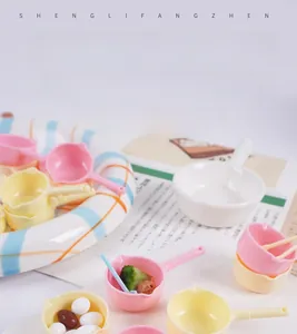 Miniature plastic water ladles in pink, yellow, and white with tiny food props for dollhouses