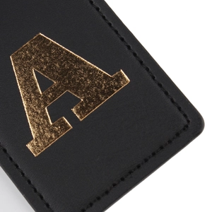 Premium black leather luggage tag with gold embossed letter A and fine stitching details