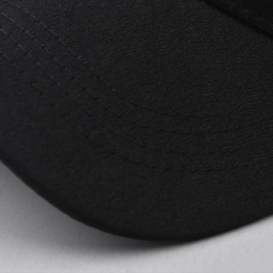Macro shot showing high-quality stitching and fabric texture on a black baseball cap