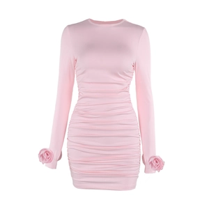 Pink long sleeve bodycon mini dress featuring ruched design and floral cuff details
