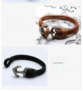 Close-up of vintage leather anchor bracelets with braided rope and metal buckle details
