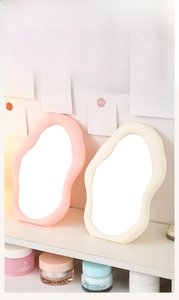 Irregular cloud-shaped desktop vanity mirrors in pink and creamy white pastel colors