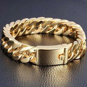 Detail of 10mm gold plated Cuban link bracelet with square box clasp on black background