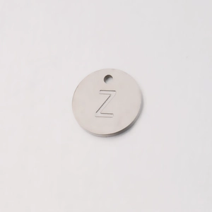 Macro shot of mirror-polished stainless steel 12mm round charm with engraved letter Z