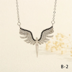 Detailed view of silver angel wing pendant with micro-pave black and white zircons