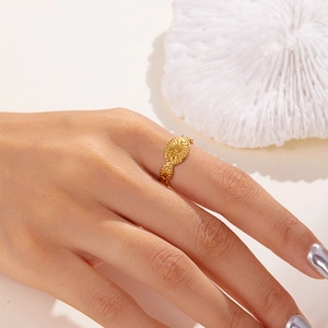 Close-up of a gold-plated irregular geometric stainless steel ring worn on a model's hand