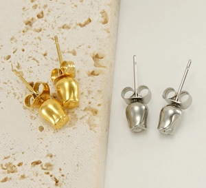 Detailed view of rose bud stud earrings in polished gold and silver stainless steel