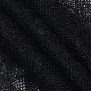Macro shot of black lace fabric texture with intricate floral mesh patterns for corset tops
