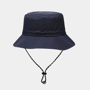 Detail of dark blue waterproof sun hat featuring reinforced brim and polka dot wind cord