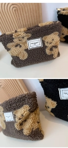 Close-up of plush teddy bear pattern and soft lamb wool fabric on a makeup bag