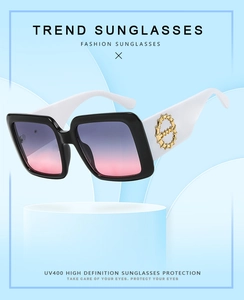 Detail of square sunglasses with black and white frame and purple gradient UV400 lenses