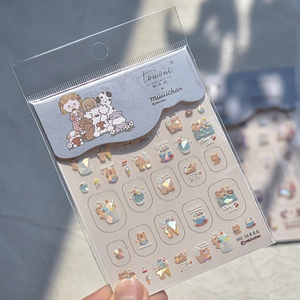 Macro detail of iridescent shell-light nail stickers featuring cute dog and bear patterns