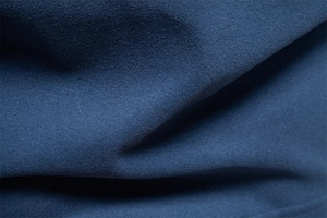 Macro shot of navy blue thermal fabric texture with high-density knit and soft finish