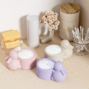 Three cute bunny candle holders in pink, purple and beige with a matte finish on desk