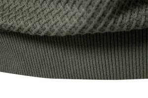 Close-up of army green waffle knit texture and ribbed cuff on men sweater