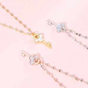 Detailed view of key necklaces in gold, silver, and rose gold with shell inlays