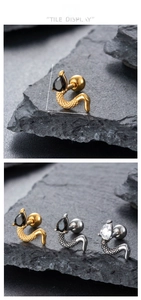 Macro detail of snake-shaped earring with zircon stones and S-shaped scale texture
