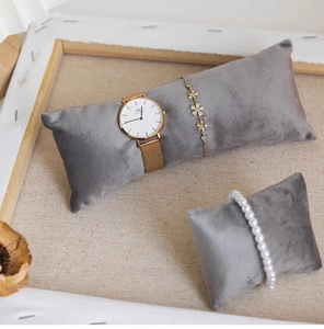 Detailed view of grey velvet jewelry display pillows for watches and bracelets