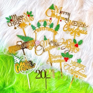 Gold acrylic Merry Christmas and 2024 cake toppers with green tree and holly decorations