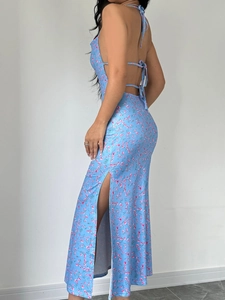 Floral halter neck sleeveless dress with backless design and high side slit in blue