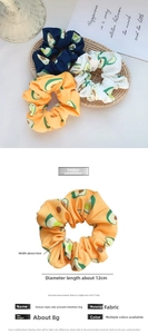 Detail view of avocado pattern hair scrunchies showing 12cm diameter and fabric material