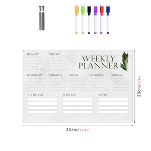 Macro view of acrylic weekly planner set with marble texture and colorful magnetic pens