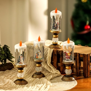Detailed view of four Christmas snow globe candle lamps with festive scenes