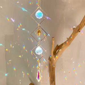 Detail of sun catcher showing golden metal frames and crystal prisms creating rainbows