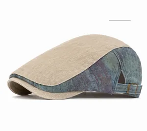 Detail view of khaki and washed blue denim newsboy cap with metal buckle and stitching