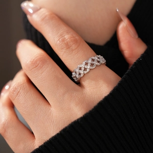 Macro detail of silver plated hollow flower ring with cubic zirconia on woman's finger