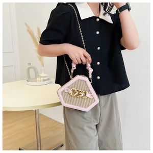 Detail of diamond straw shoulder bag with pink PU trim and gold chunky chain handle