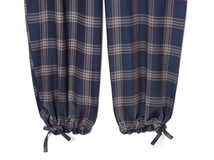 Close-up of deep blue plaid cargo pants featuring adjustable drawstring cuffs and ties