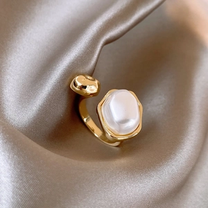 Vintage style open ring with irregular pearl on a champagne silk background