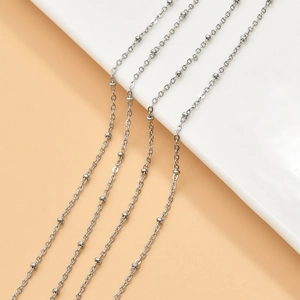Macro view of silver color stainless steel O-chains and bead link jewelry accessories