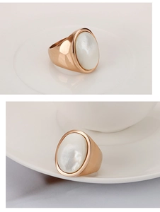 Macro detail of rose gold stainless steel ring with elegant oval white shell inlay