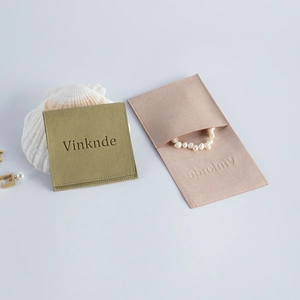 Detail of sage green and nude pink microfiber velvet envelope pouches for jewelry storage