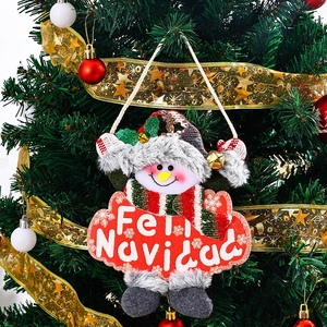 Close-up of plush Christmas snowman ornament hanging on a tree with Feliz Navidad greeting