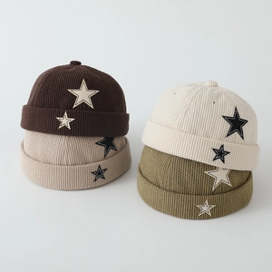 Detailed view of kids corduroy miki hats with star patches in multiple colors