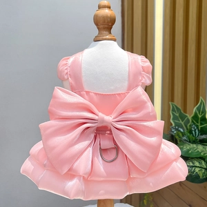 Pink pet wedding dress with large bow and leash ring on a mannequin, back detail view