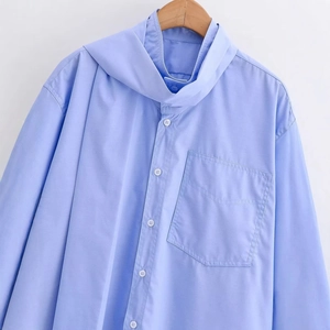Light blue long-sleeved button-down shirt with chest pocket on wooden hanger
