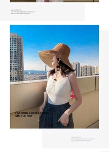 Detail of wide brim sun hat showing brown outer layer and beige inner canvas texture