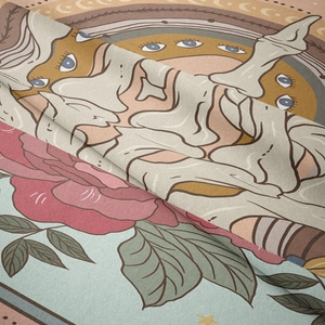 Close-up of tarot tapestry showing a mystic sun, red roses, and soft velvet texture