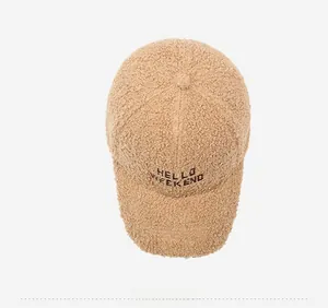 Detailed top view of a beige faux shearling baseball cap with HELLO WEEKEND embroidery