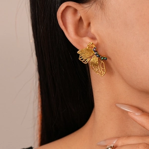 French retro gold metal butterfly earrings with colorful beads on female model