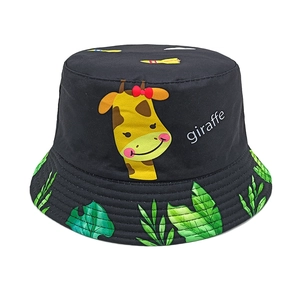 Detail of kids black bucket hat with cartoon giraffe print and monstera leaf patterns