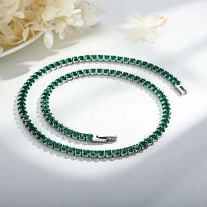 Detailed close-up of emerald green cubic zirconia tennis necklace with S925 silver base