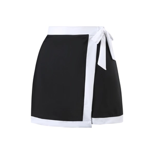 Detail of a black wrap mini skirt with white contrast trim and side bow tie design