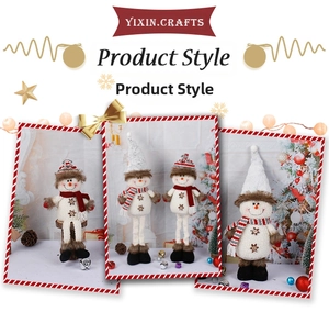 Detailed view of standing snowman plush figurines with red hats and striped scarves