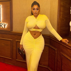 Bright yellow two-piece set featuring cross-knot long sleeve crop top and ruched maxi skirt