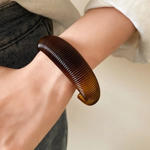 French vintage brown resin open thick spiral textured bangle for women on model